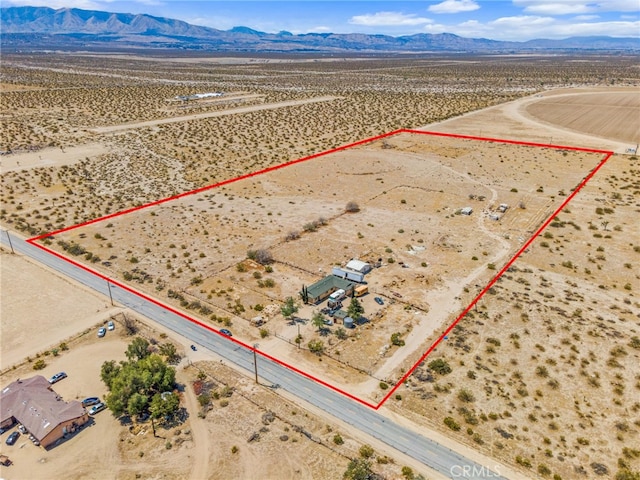 drone / aerial view with a rural view, view of desert, and a mountain view