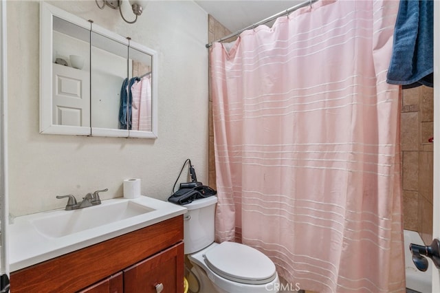 full bathroom with toilet, vanity, and curtained shower