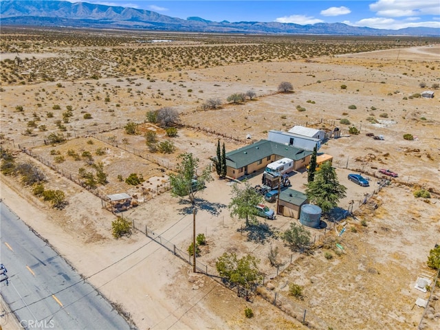 birds eye view of property featuring a mountain view, a rural view, and view of desert