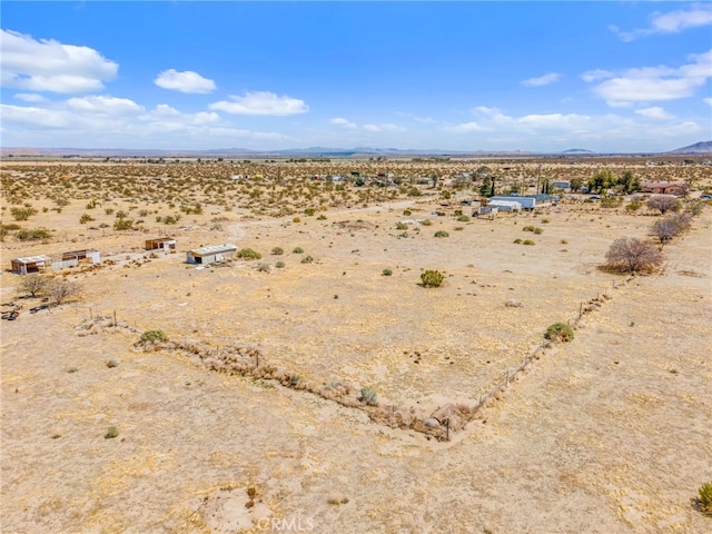 drone / aerial view with a rural view, a desert view, and a mountain view