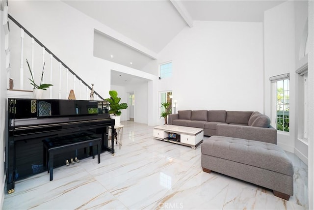 living area featuring beamed ceiling, marble finish floor, high vaulted ceiling, and stairway