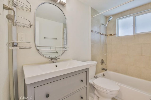 bathroom with toilet, vanity, and bathing tub / shower combination