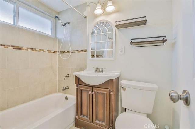 bathroom with bathtub / shower combination, vanity, and toilet