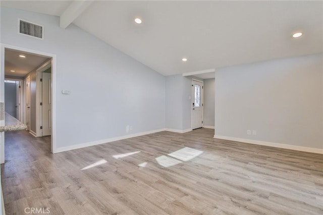 empty room with baseboards, wood finished floors, visible vents, and vaulted ceiling with beams