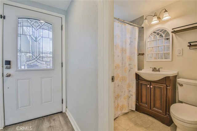 full bathroom featuring toilet, vanity, and curtained shower