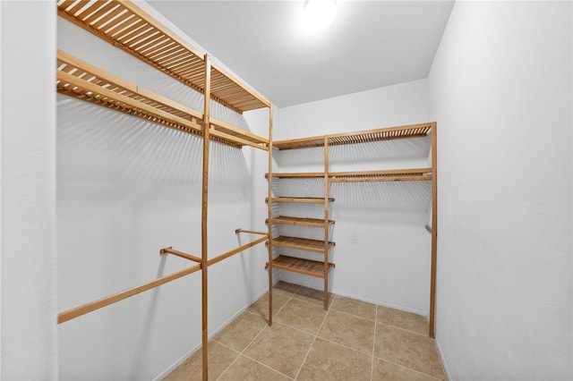 spacious closet with tile patterned floors