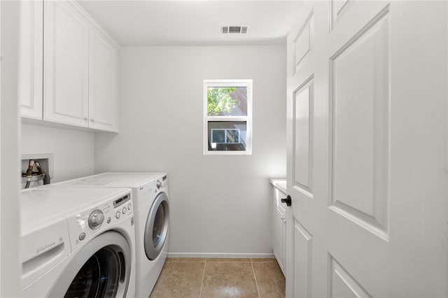 laundry area featuring cabinet space, washer and dryer, baseboards, light tile patterned floors, and visible vents