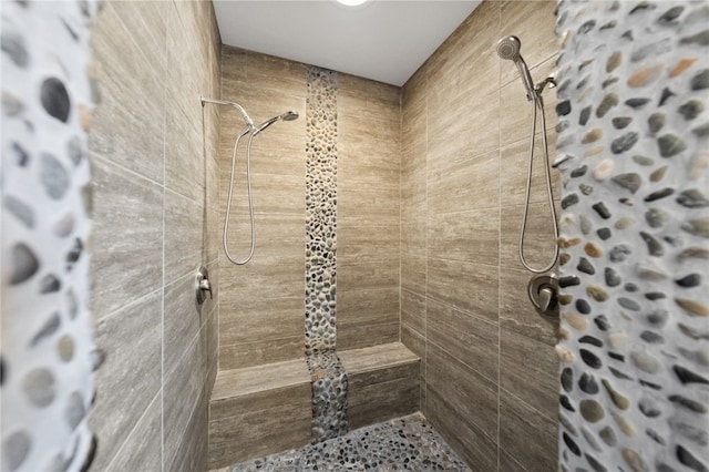 bathroom with a tile shower