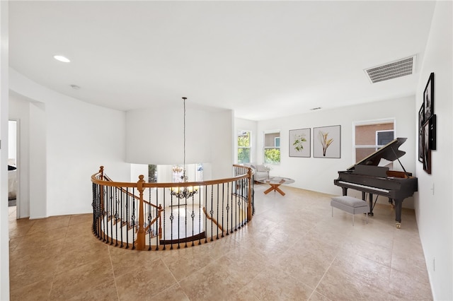 hall with a chandelier, visible vents, tile patterned flooring, an upstairs landing, and recessed lighting