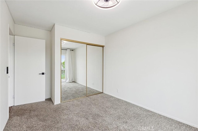 unfurnished bedroom with carpet floors and a closet