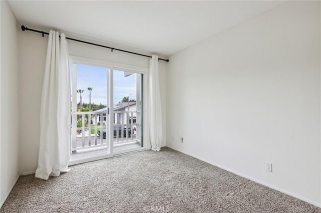 empty room with baseboards and carpet floors