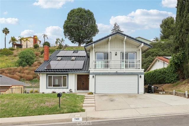 view of front facade with driveway, board and batten siding, a front yard, a garage, and solar panels