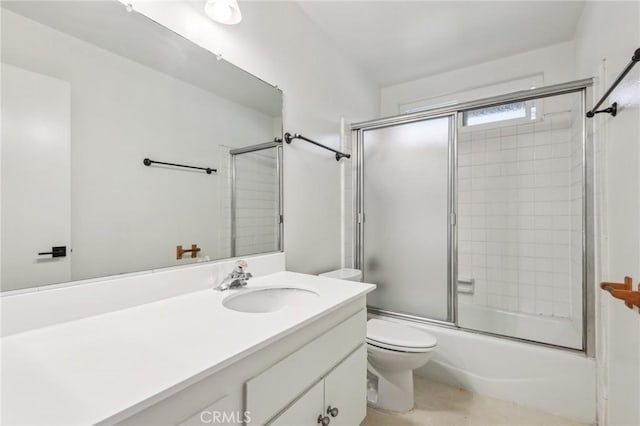 full bath with toilet, vanity, tile patterned floors, and combined bath / shower with glass door