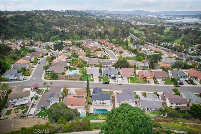 birds eye view of property with a residential view and a mountain view