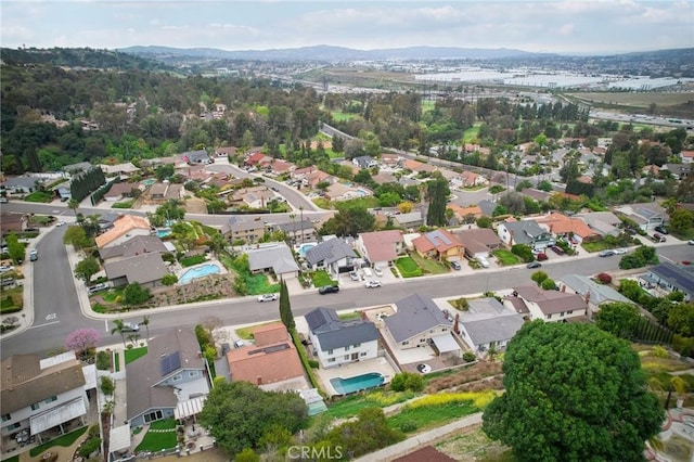 birds eye view of property with a mountain view and a residential view