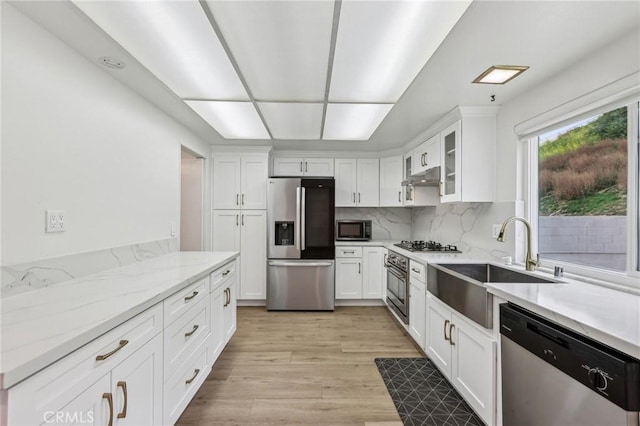 kitchen with white cabinets, appliances with stainless steel finishes, and a sink