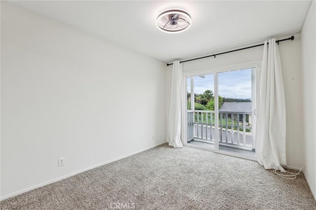 spare room with carpet floors and baseboards
