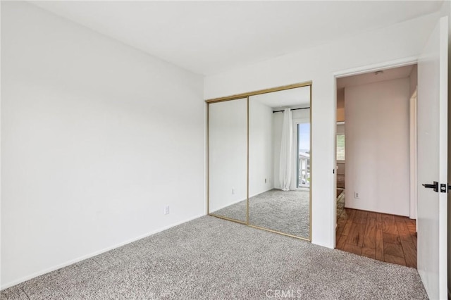 unfurnished bedroom featuring a closet and carpet
