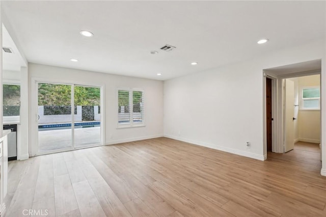 empty room featuring recessed lighting, baseboards, visible vents, and light wood-type flooring