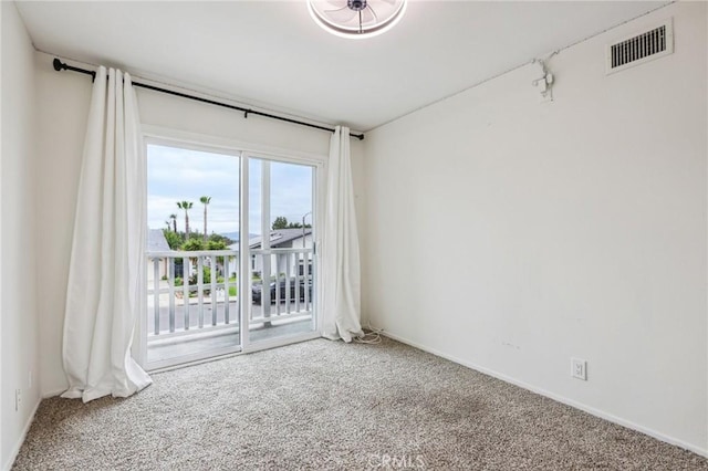 empty room with carpet flooring and visible vents