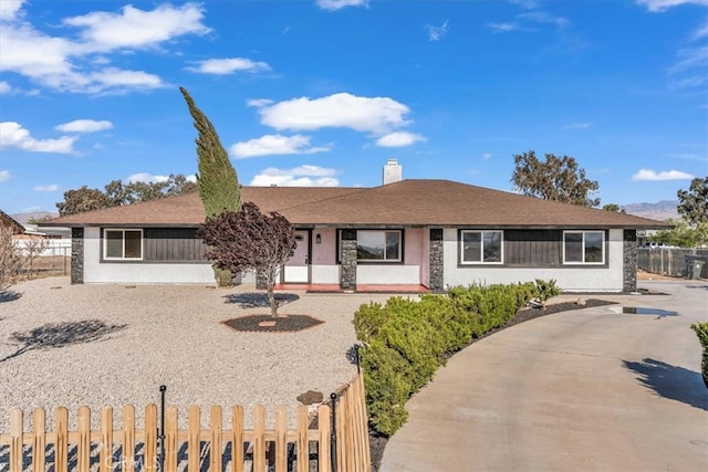 single story home with a chimney and fence private yard