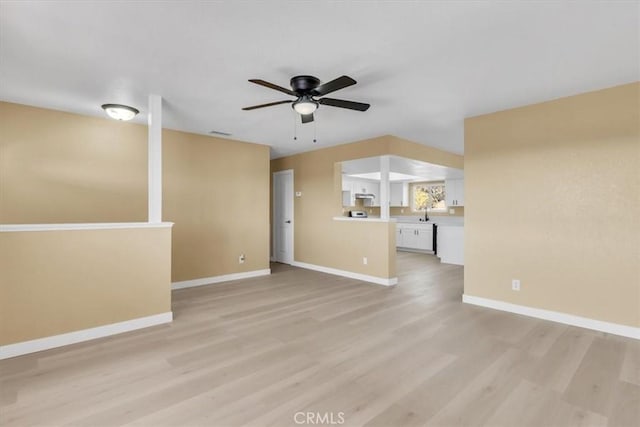 unfurnished living room featuring baseboards, light wood-style floors, and ceiling fan