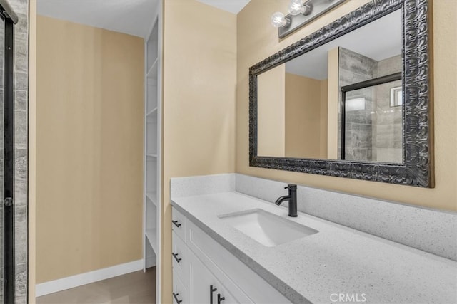 bathroom with vanity and tiled shower