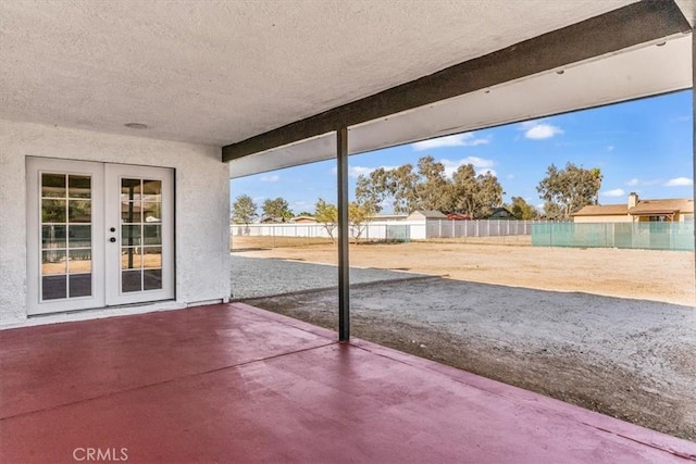 view of patio featuring fence and french doors