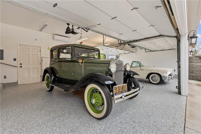 garage featuring electric panel, a wall unit AC, and a garage door opener