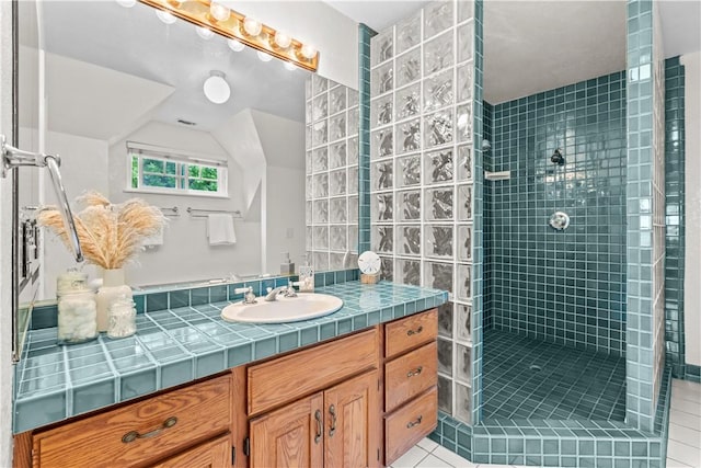 bathroom with lofted ceiling, tile patterned floors, walk in shower, and vanity