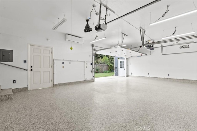 garage with a garage door opener, electric panel, and a wall mounted AC