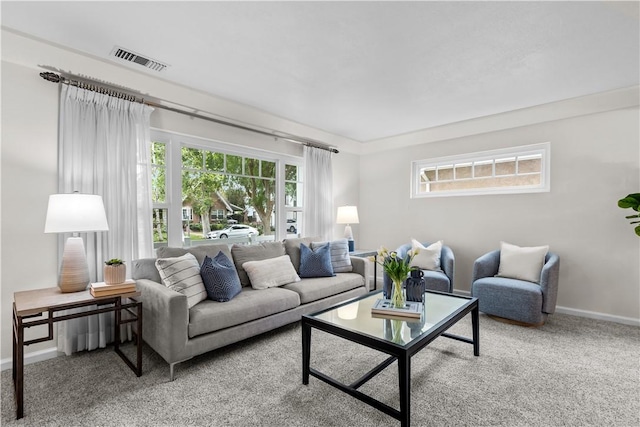 living area with visible vents, carpet flooring, and baseboards