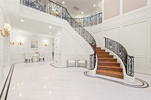 435 Walnut Ave, Arcadia, CA 91007 - stairway with a decorative wall, crown molding, a towering ceiling, inlaid floor details, and recessed lighting