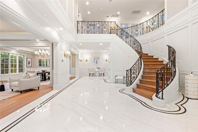 435 Walnut Ave, Arcadia, CA 91007 - foyer entrance with a decorative wall, a chandelier, crown molding, a towering ceiling, and stairs