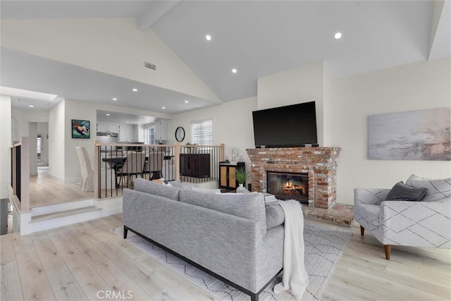 1727 Spreckels Ln, Redondo Beach, CA 90278 - living room featuring visible vents, a fireplace, beamed ceiling, light wood finished floors, and recessed lighting