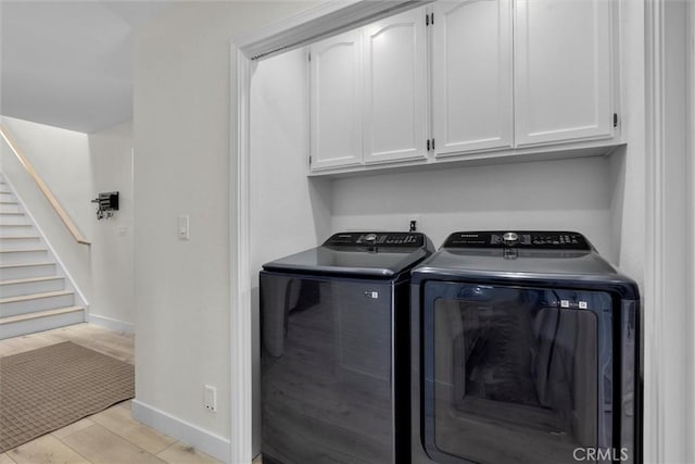 1727 Spreckels Ln, Redondo Beach, CA 90278 - laundry room with baseboards, light wood finished floors, cabinet space, and washer and clothes dryer