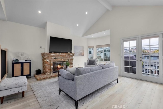 1727 Spreckels Ln, Redondo Beach, CA 90278 - living area featuring french doors, a brick fireplace, beam ceiling, high vaulted ceiling, and light wood finished floors