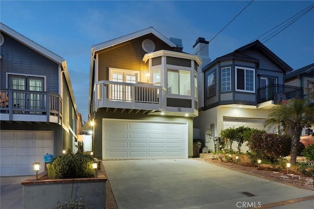 1727 Spreckels Ln, Redondo Beach, CA 90278 - view of front of home with an attached garage, concrete driveway, stucco siding, and a balcony