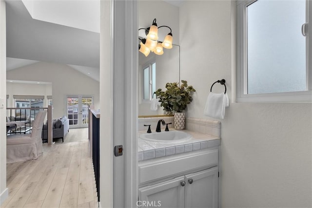 1727 Spreckels Ln, Redondo Beach, CA 90278 - ensuite bathroom with decorative backsplash, wood finished floors, vanity, lofted ceiling, and ensuite bathroom
