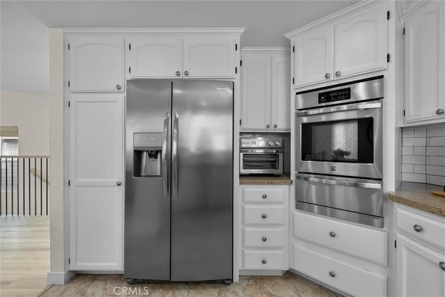 1727 Spreckels Ln, Redondo Beach, CA 90278 - kitchen with decorative backsplash, a toaster, white cabinets, a warming drawer, and stainless steel appliances