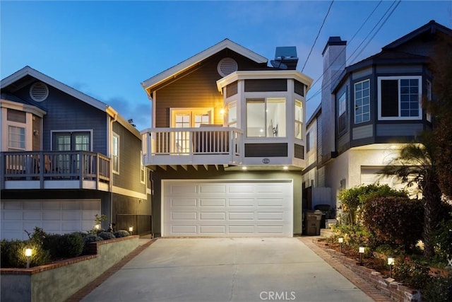 1727 Spreckels Ln, Redondo Beach, CA 90278 - view of front of property with a garage, stucco siding, concrete driveway, and a balcony