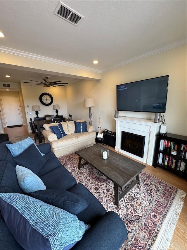 30902 Clubhouse Dr Unit 11J, Laguna Niguel, CA 92677 - living room with a fireplace, wood finished floors, visible vents, and ornamental molding