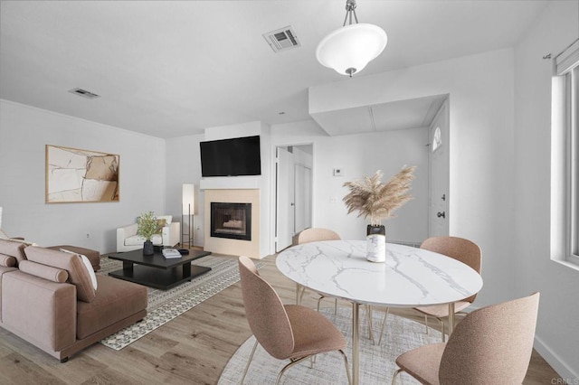 10774 Dabney Dr Unit 17, San Diego, CA 92126 - dining room featuring light wood-style floors and a fireplace