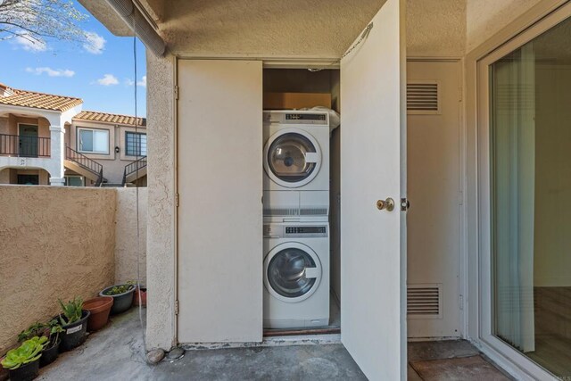 10774 Dabney Dr Unit 17, San Diego, CA 92126 - laundry area featuring stacked washing machine and dryer