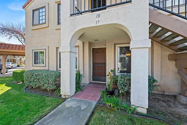 10774 Dabney Dr Unit 17, San Diego, CA 92126 - view of exterior entry featuring stucco siding and a balcony