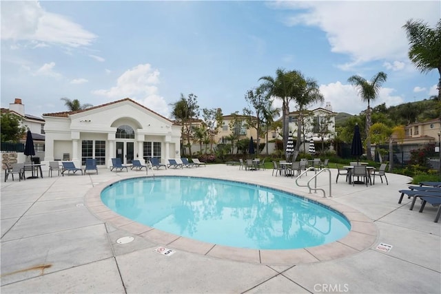 pool with fence and a patio