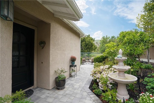 view of patio featuring fence
