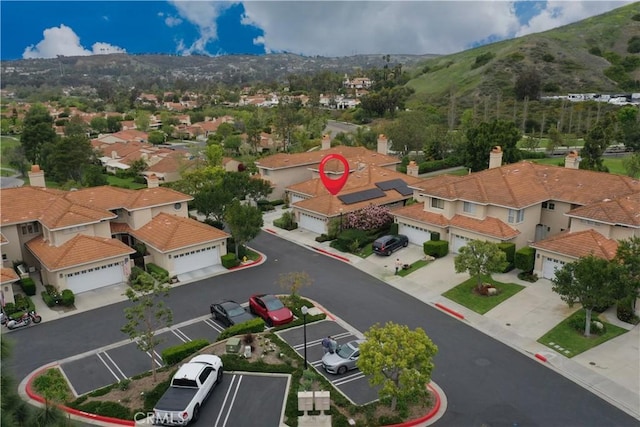 birds eye view of property featuring a mountain view and a residential view