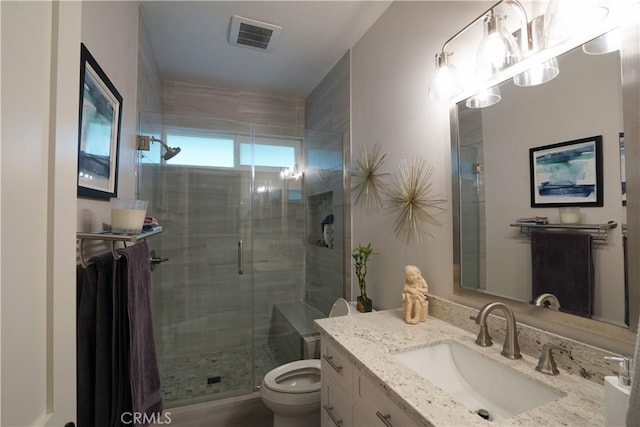 full bathroom with visible vents, toilet, a stall shower, and vanity