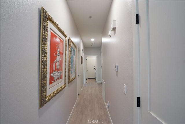 corridor with recessed lighting, light wood-style flooring, and baseboards